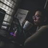 man holding mug in front laptop computer